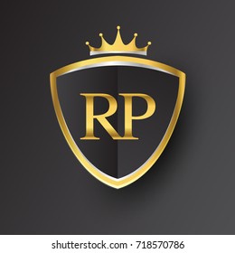 Initial logo letter RP with shield and crown Icon golden color isolated on black background, logotype design for company identity.