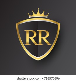 Initial logo letter RR with shield and crown Icon golden color isolated on black background, logotype design for company identity.