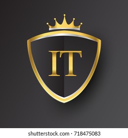 Initial logo letter IT with shield and crown Icon golden color isolated on black background, logotype design for company identity.