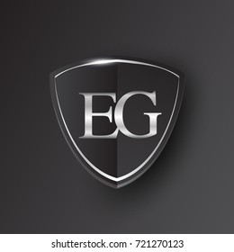 Initial logo letter EG with shield Icon silver color isolated on black background, logotype design for company identity.