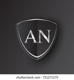 Initial logo letter AN with shield Icon silver color isolated on black background, logotype design for company identity.