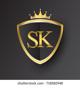 Initial logo letter SK with shield and crown Icon golden color isolated on black background, logotype design for company identity.