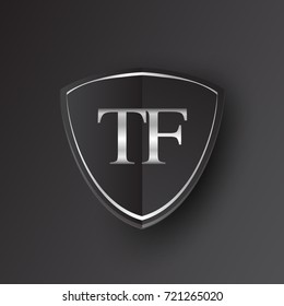 Initial logo letter TF with shield Icon silver color isolated on black background, logotype design for company identity.