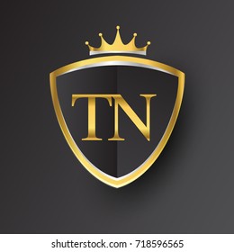 Initial logo letter TN with shield and crown Icon golden color isolated on black background, logotype design for company identity.