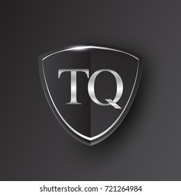 Initial logo letter TQ with shield Icon silver color isolated on black background, logotype design for company identity.