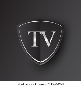 Initial logo letter TV with shield Icon silver color isolated on black background, logotype design for company identity.