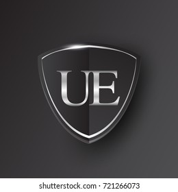 Initial logo letter UE with shield Icon silver color isolated on black background, logotype design for company identity.