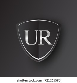 Initial logo letter UR with shield Icon silver color isolated on black background, logotype design for company identity.