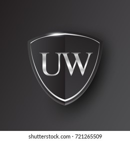 Initial logo letter UW with shield Icon silver color isolated on black background, logotype design for company identity.