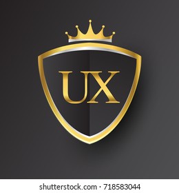 Initial logo letter UX with shield and crown Icon golden color isolated on black background, logotype design for company identity.