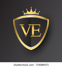Initial logo letter VE with shield and crown Icon golden color isolated on black background, logotype design for company identity.