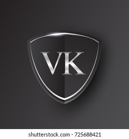 Initial logo letter VK with shield Icon silver color isolated on black background, logotype design for company identity.