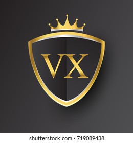 Initial logo letter VX with shield and crown Icon golden color isolated on black background, logotype design for company identity.