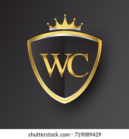 Initial logo letter WC with shield and crown Icon golden color isolated on black background, logotype design for company identity.