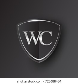 Initial logo letter WC with shield Icon silver color isolated on black background, logotype design for company identity.