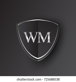 Initial logo letter WM with shield Icon silver color isolated on black background, logotype design for company identity.