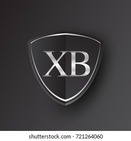 Initial logo letter XB with shield Icon silver color isolated on black background, logotype design for company identity.