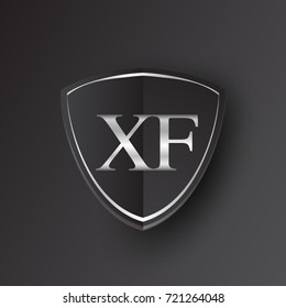 Initial logo letter XF with shield Icon silver color isolated on black background, logotype design for company identity.