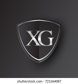 Initial logo letter XG with shield Icon silver color isolated on black background, logotype design for company identity.