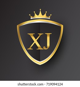 Initial logo letter XJ with shield and crown Icon golden color isolated on black background, logotype design for company identity.