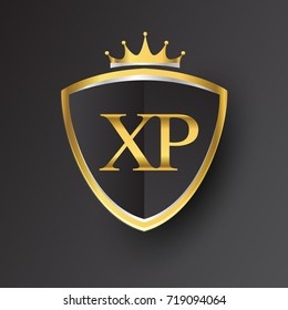 Initial logo letter XP with shield and crown Icon golden color isolated on black background, logotype design for company identity.
