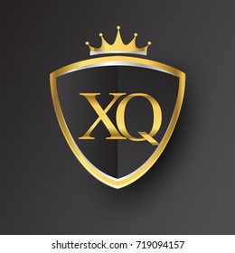 Initial logo letter XQ with shield and crown Icon golden color isolated on black background, logotype design for company identity.