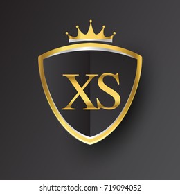 Initial logo letter XS with shield and crown Icon golden color isolated on black background, logotype design for company identity.