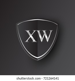 Initial logo letter XW with shield Icon silver color isolated on black background, logotype design for company identity.
