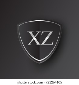 Initial logo letter XZ with shield Icon silver color isolated on black background, logotype design for company identity.