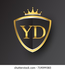 Initial logo letter YD with shield and crown Icon golden color isolated on black background, logotype design for company identity.