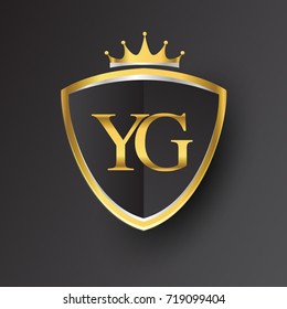 Initial logo letter YG with shield and crown Icon golden color isolated on black background, logotype design for company identity.