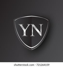 Initial logo letter YN with shield Icon silver color isolated on black background, logotype design for company identity.