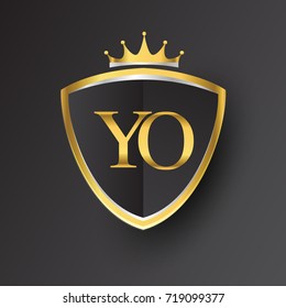 Initial logo letter YO with shield and crown Icon golden color isolated on black background, logotype design for company identity.