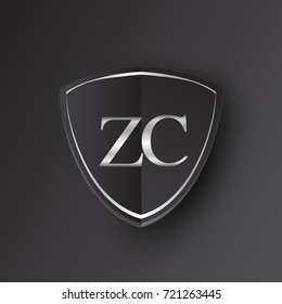Initial logo letter ZC with shield Icon silver color isolated on black background, logotype design for company identity.