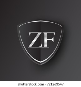 Initial logo letter ZF with shield Icon silver color isolated on black background, logotype design for company identity.