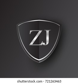 Initial logo letter ZJ with shield Icon silver color isolated on black background, logotype design for company identity.