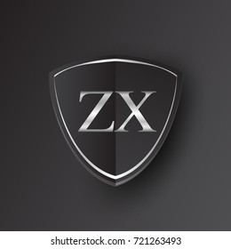 Initial logo letter ZX with shield Icon silver color isolated on black background, logotype design for company identity.