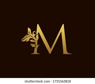 Initial M Gold Leaf Logo Design . Graceful style.  Vintage drawn emblem for book design, wedding ornament, brand name, letter stamp, Restaurant, Boutique, Hotel.  