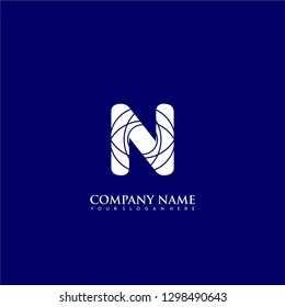 initial N logo letter with abstract circle lines pattern symbol design concept in blue background color