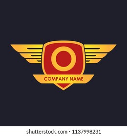 A initial shield with wings gold color logo