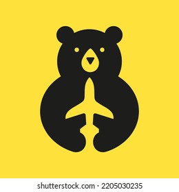 Initial Travel Bear Logo Negative Space Vector Template. Bear Holding Airplane Symbol