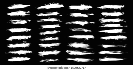 Ink splashes vector set. High quality smeared strokes. White ink splatter dirt stain splattered with drops, isolated on black background. Isolated vector grunge silhouette set. High quality vector set