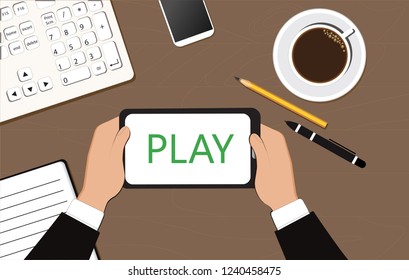 The inscription "play" on the display of the tablet in the hands of a businessman. Business and Finance.