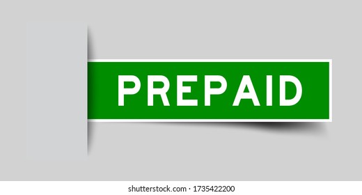 Inserted green color sticker label with word prepaid on gray background