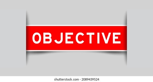 Inserted red color label sticker with word objective on gray background