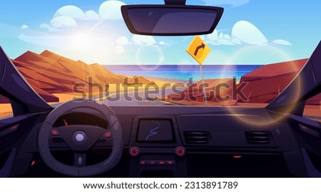 Inside car view on desert road to sea shore landscape. Turn sign on highway for direction drive to ocean beach coast. Steering control with navigation interface and windscreen scene on water and rock