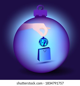 Inside the glass ball designed to decorate the Christmas holiday is a hand taking out a Christmas tree toy from the package symbolizing the new year 2021.