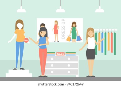 Inside maternity shop. Pregnant women buying clothes.