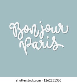 Inspirational quote bonjour Paris. Hand lettering design element. Ink brush calligraphy.