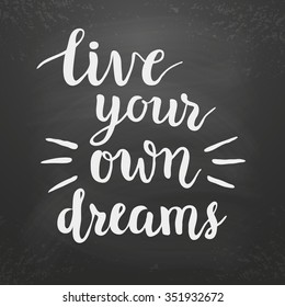 Inspirational quote "Live your own dreams" on chalkboard background.Hand lettering typography poster. Ink brush calligraphy. Vector illustration